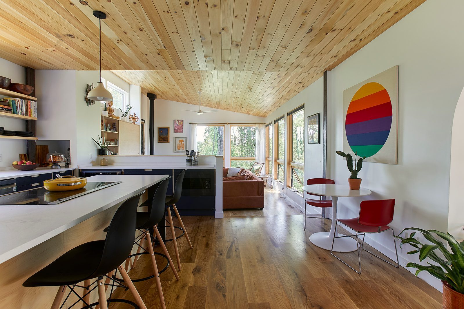 cosy kitchen with a wood burning stove, low ceilings, and big windows.
