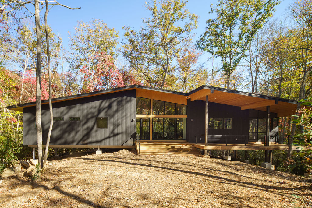 Modern mountain home designed by top Asheville architects featuring sustainable timber framing, expansive glass walls, and Blue Ridge views