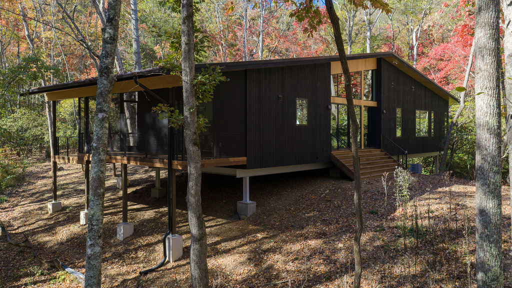 Luxury custom mountain home in Asheville NC with timber frame construction, floor-to-ceiling windows, and panoramic Blue Ridge Mountain views