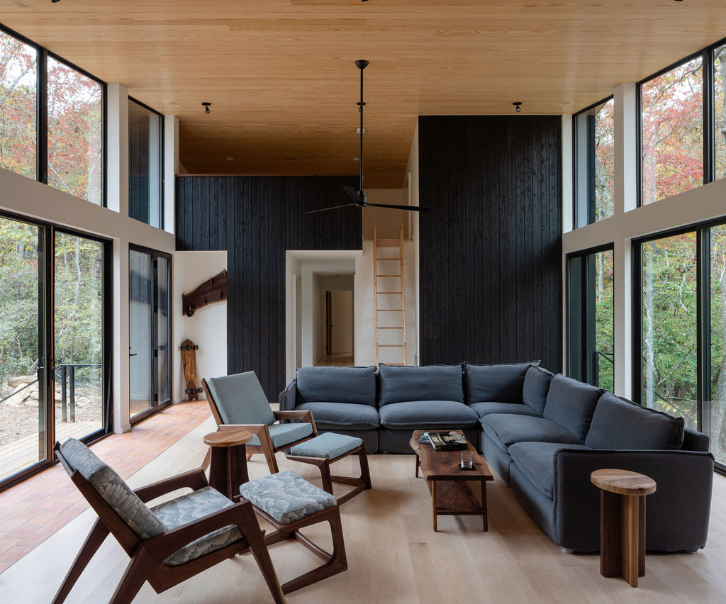 Ultra-sustainable Asheville home featuring black walls, all-wood craftsmanship, vaulted sloped ceilings & expansive floor-to-ceiling windows.